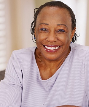 Smiling woman with dentures in Virginia Beach