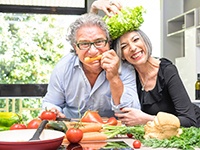 An older couple eating fresh food