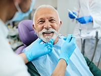 A happy senior man receiving dental care