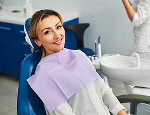 Woman smiling while sitting in treatment chair