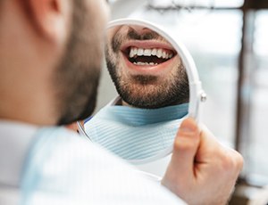 A man smiling at his tooth-colored filling