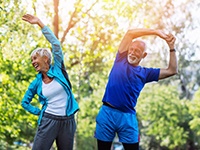 senior couple stretching before they exercise outside 
