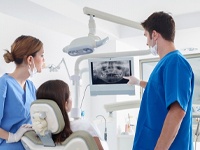 implant dentist in Virginia Beach showing a patient their dental X-rays