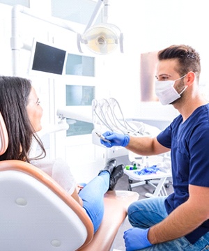 Woman at dentist using dental insurance in Virginia Beach.