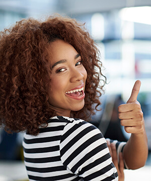 Smiling woman giving thumbs up