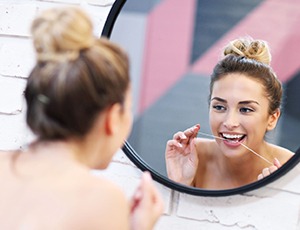 woman flossing for teeth whitening in Virginia Beach 