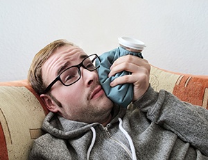Teen holding cheek due to wisdom tooth pain