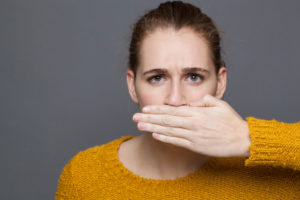 Woman hiding bad breath