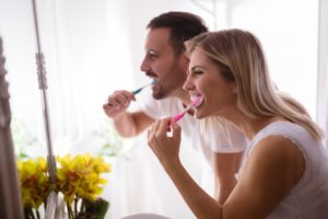 Couple brushing teeth together.