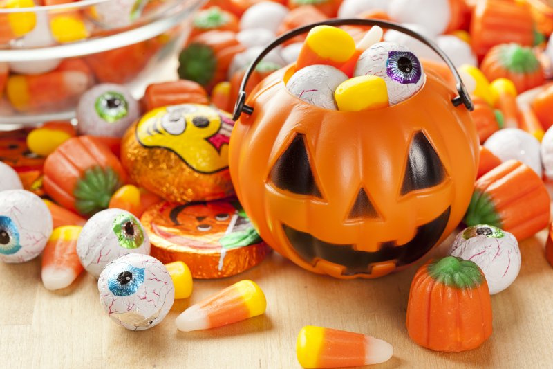 Plastic pumpkin filled with Halloween candy