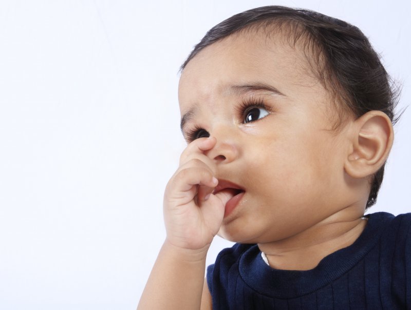 child sucking their thumb