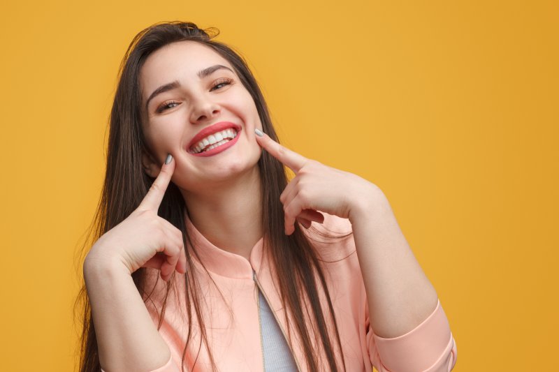 Lady shows off pretty teeth.